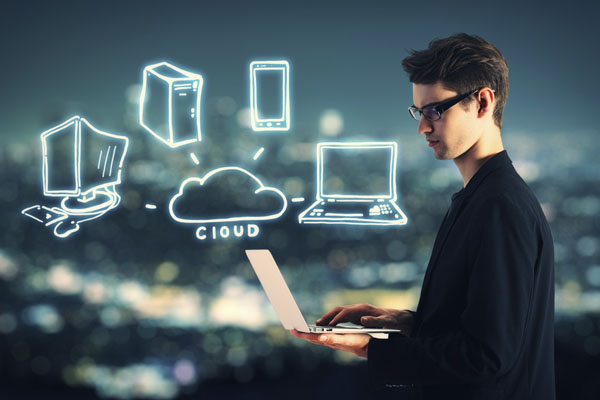 man with laptop and abstract image of connected devices in the cloud